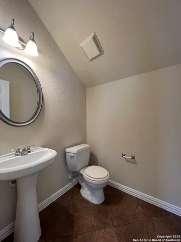 a bathroom with a sink toilet and a mirror