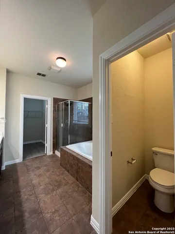 a bathroom with a toilet and a shower