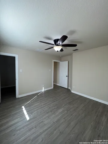 a view of empty room with wooden floor