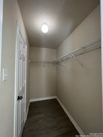 a view of a room with wooden floor