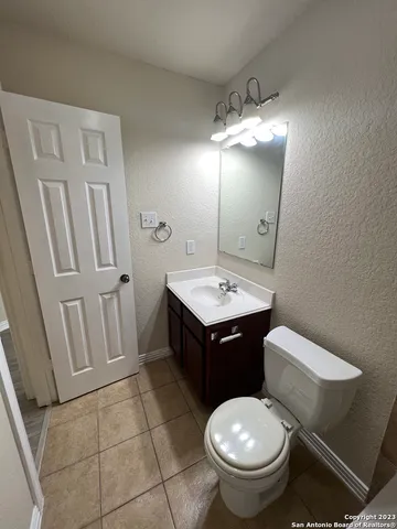 a bathroom with a toilet sink and mirror