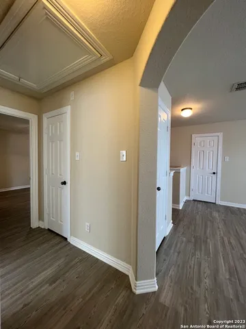a view of a hallway with wooden floor