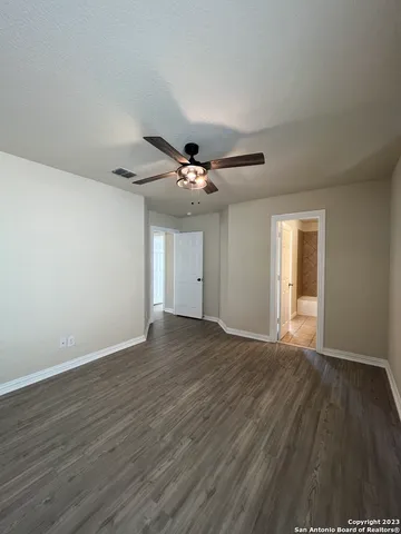a view of an empty room and wooden floor