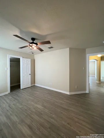 a view of an empty room with wooden floor