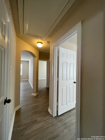 a view of a hallway with wooden floor
