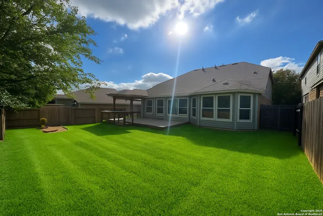 a view of a house with a backyard