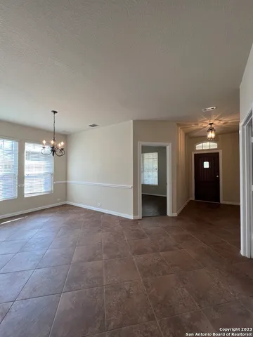 a view of a big room with chandelier and windows