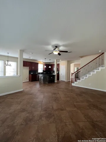 a view of empty room with fireplace and windows