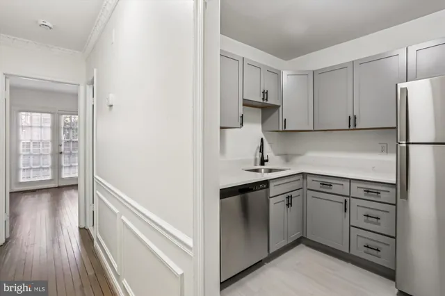 a kitchen with white cabinets and white appliances