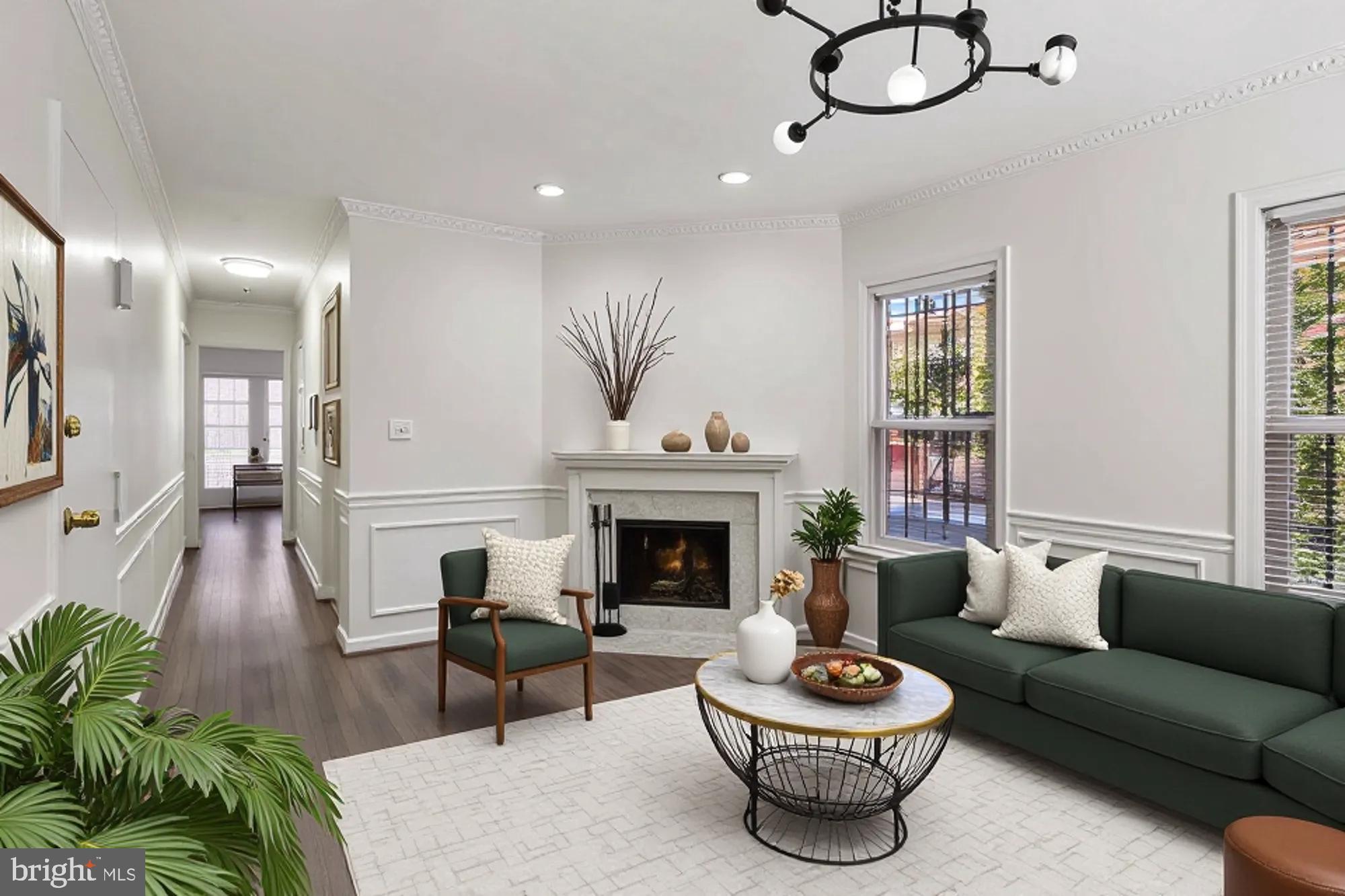 1690 Euclid Street Northwest, Unit A Washington, DC 20009 - Photo 16 of 38 a living room with furniture a fireplace and a chandelier