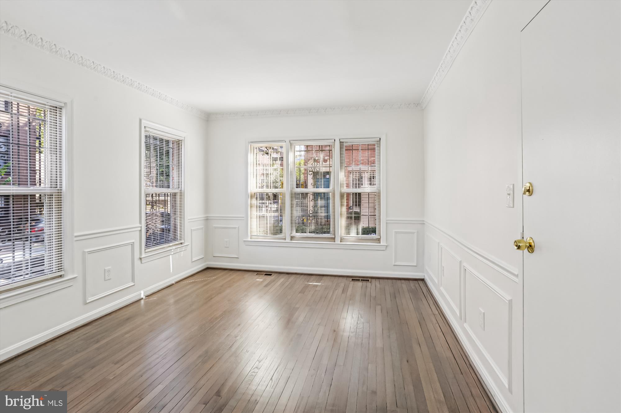 1690 Euclid Street Northwest, Unit A Washington, DC 20009 - Photo 20 of 38 a view of an empty room with wooden floor and a window
