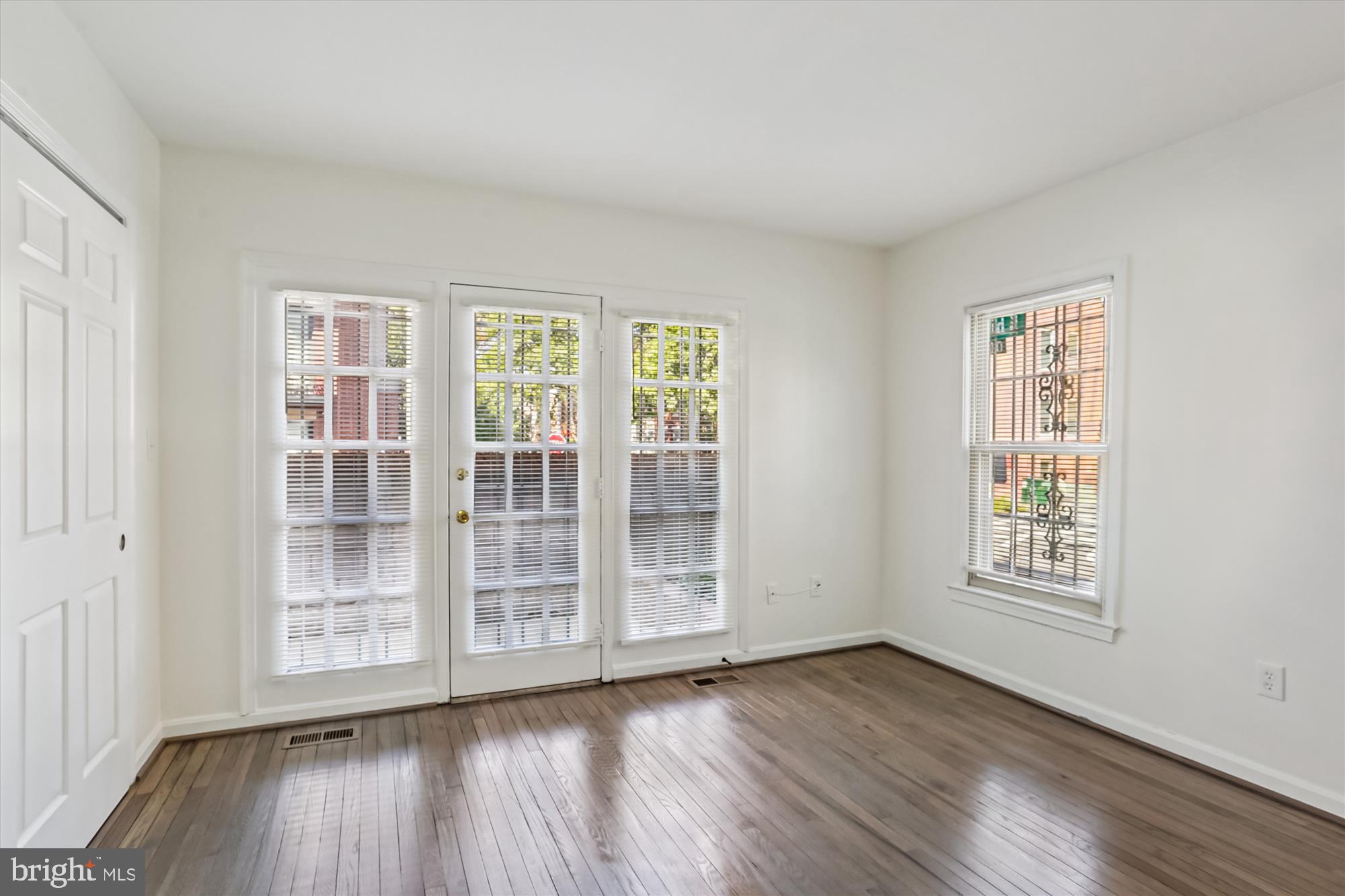 1690 Euclid Street Northwest, Unit A Washington, DC 20009 - Photo 21 of 38 a view of an empty room with wooden floor and a window