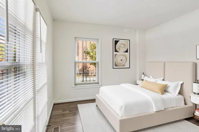 a bedroom with a large bed and a window