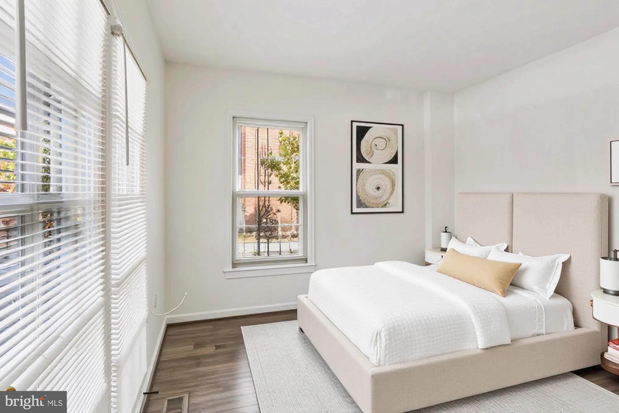 1690 Euclid Street Northwest, Unit A Washington, DC 20009 - Photo 22 of 38 a bedroom with a large bed and a window