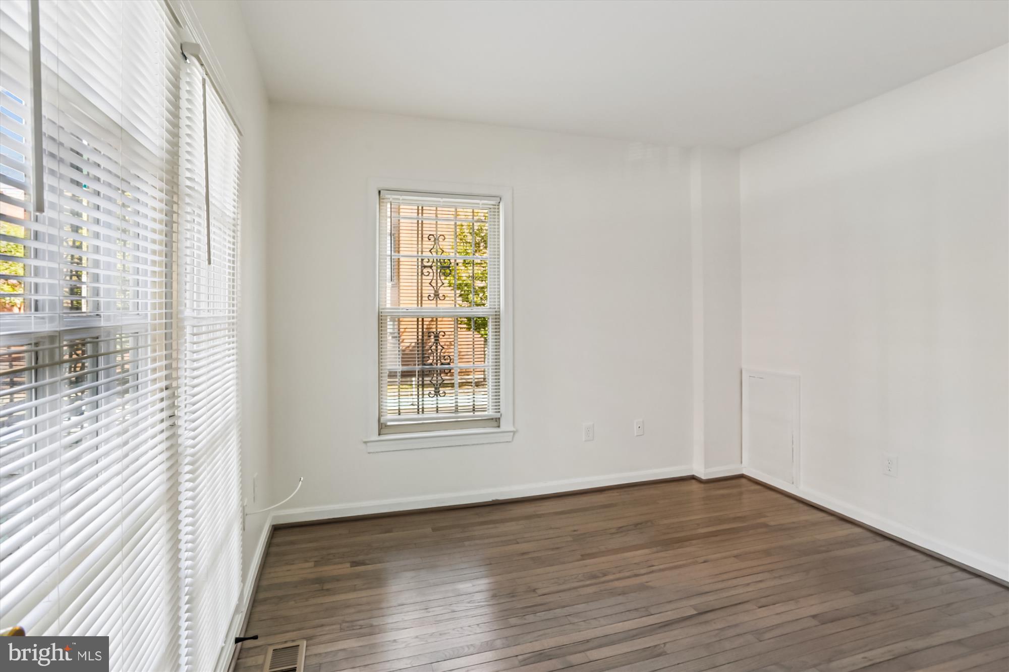 1690 Euclid Street Northwest, Unit A Washington, DC 20009 - Photo 23 of 38 a view of an empty room with wooden floor and a window