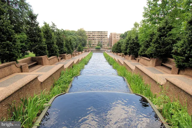 a view of flowing water with large building in front of it