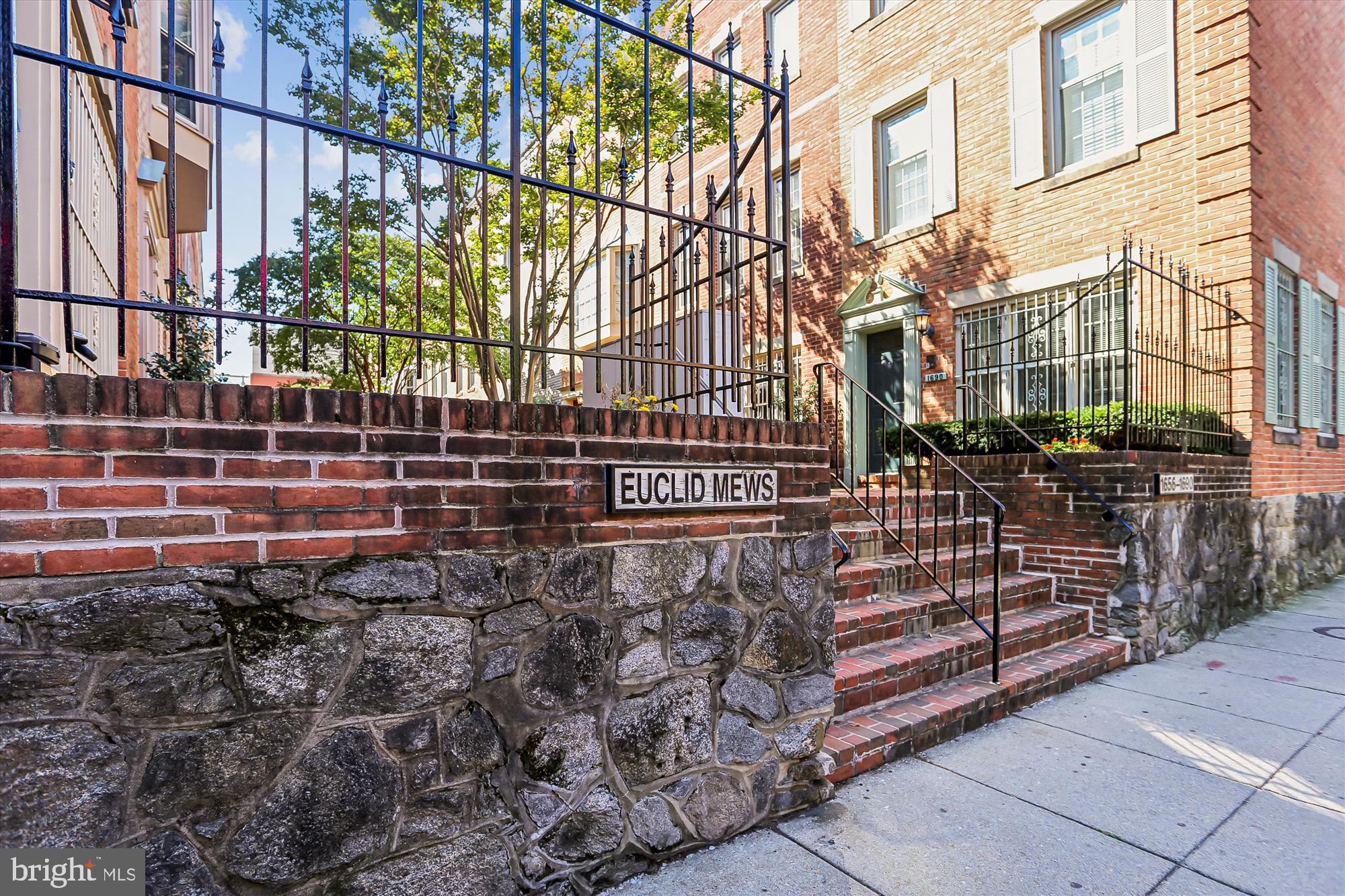 1690 Euclid Street Northwest, Unit A Washington, DC 20009 - Photo 4 of 38 a view of a pathway with a street sign on a sidewalk