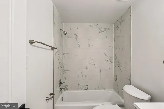 a bathroom with a shower and a toilet