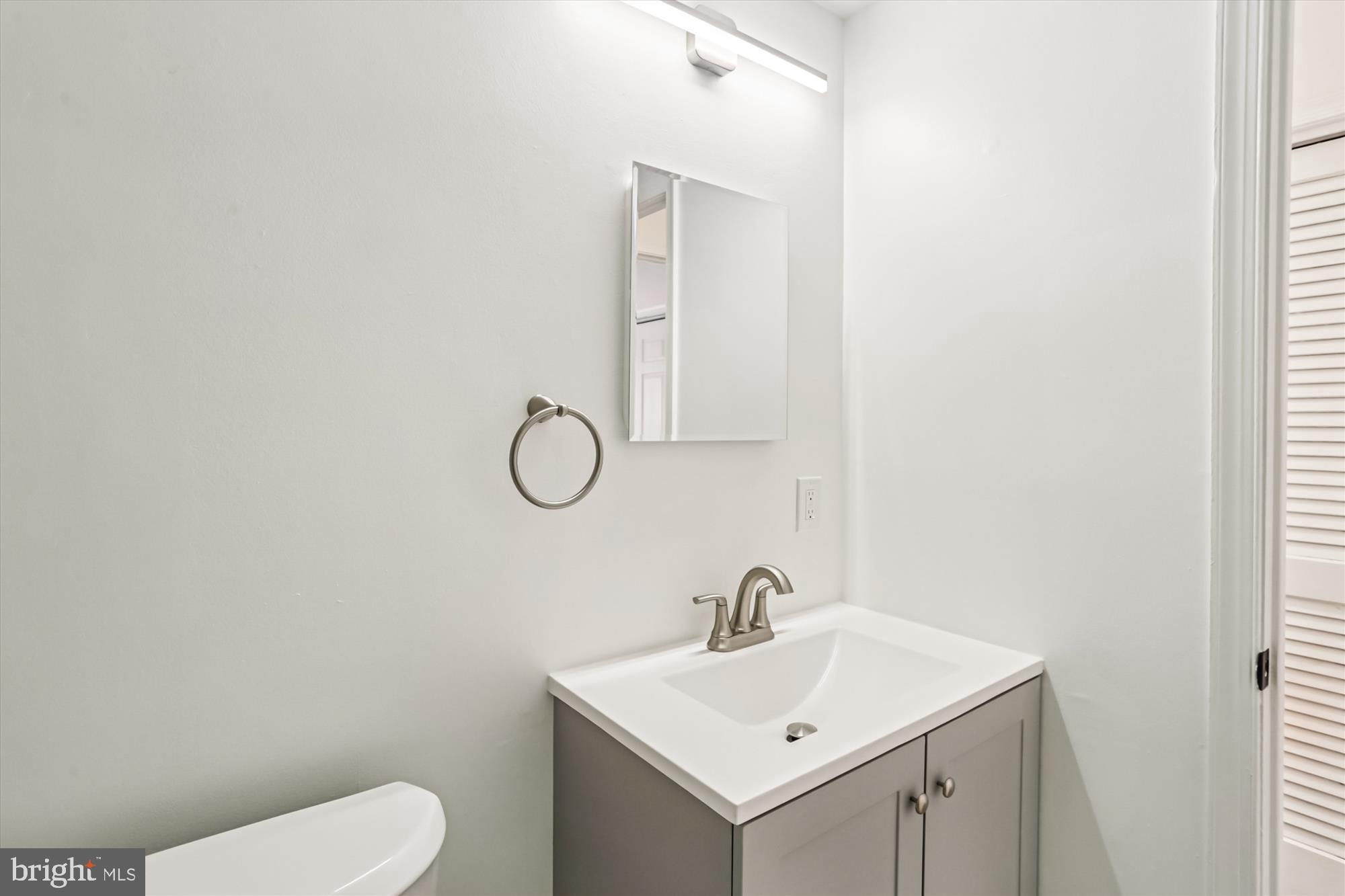1690 Euclid Street Northwest, Unit A Washington, DC 20009 - Photo 8 of 38 a bathroom with a toilet sink and mirror
