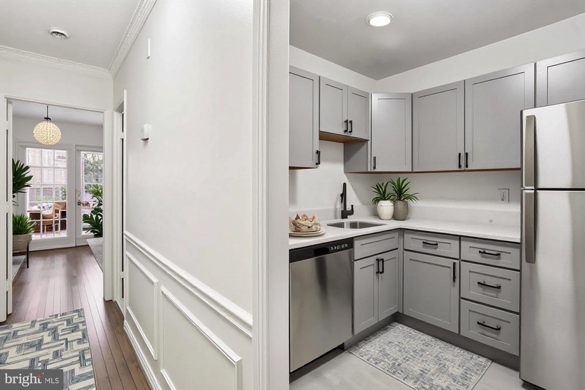 1690 Euclid Street Northwest, Unit A Washington, DC 20009 - Photo 10 of 38 a kitchen with white cabinets and white appliances