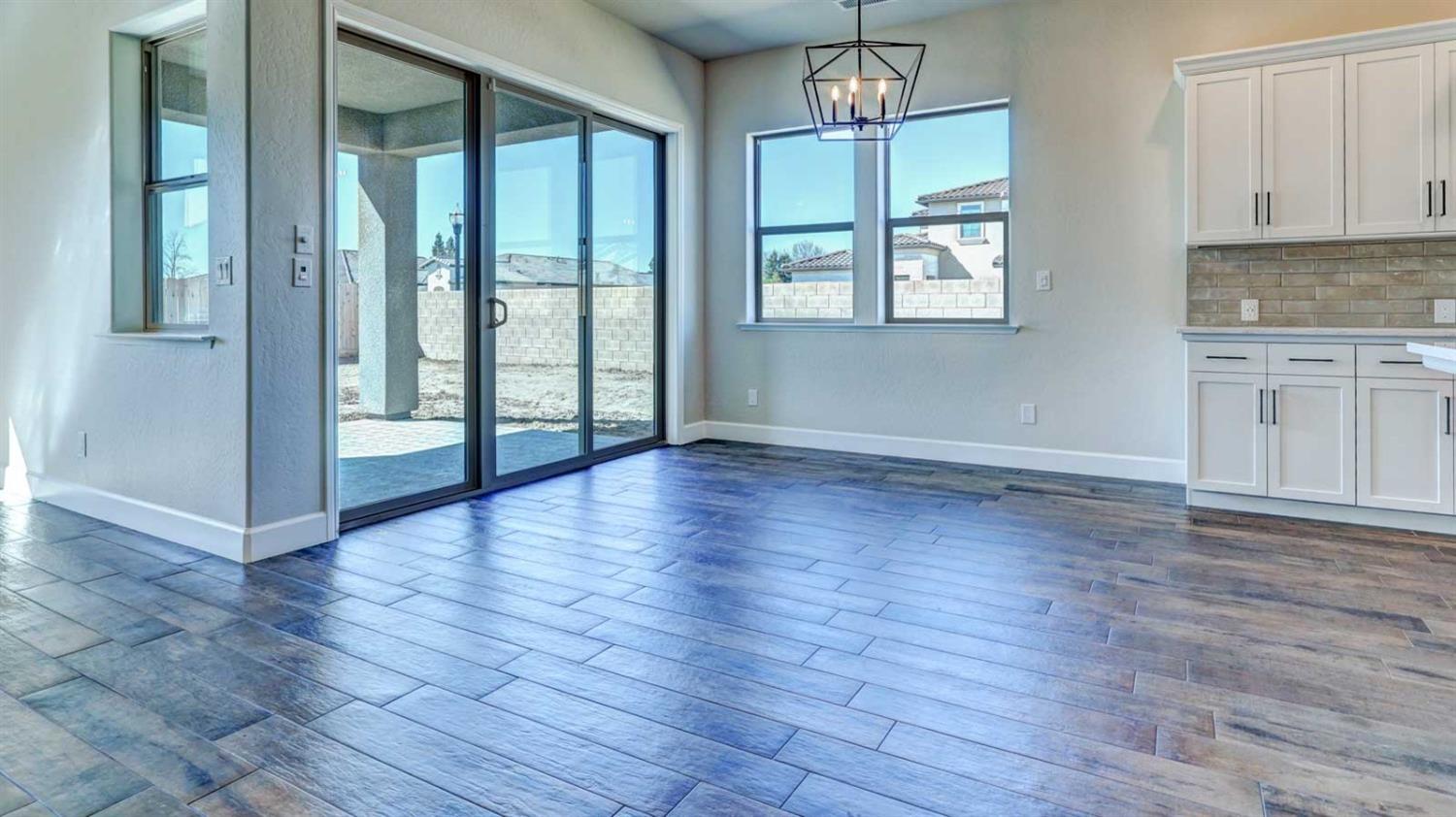 1742 North Applegate Avenue Clovis, CA 93619 - Photo 16 of 31 an empty room with wooden floor and windows