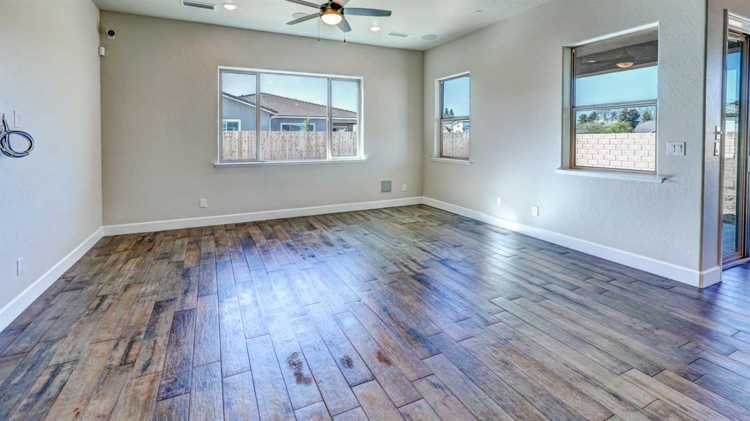 1742 North Applegate Avenue Clovis, CA 93619 - Photo 17 of 31 an empty room with wooden floor and windows
