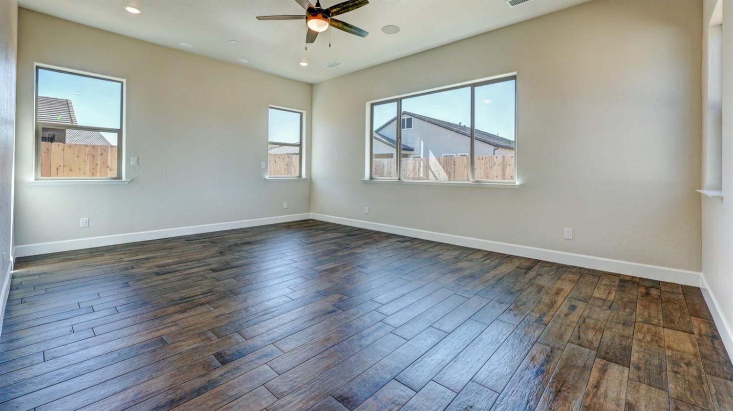 1742 North Applegate Avenue Clovis, CA 93619 - Photo 23 of 31 a view of an empty room with wooden floor and a window