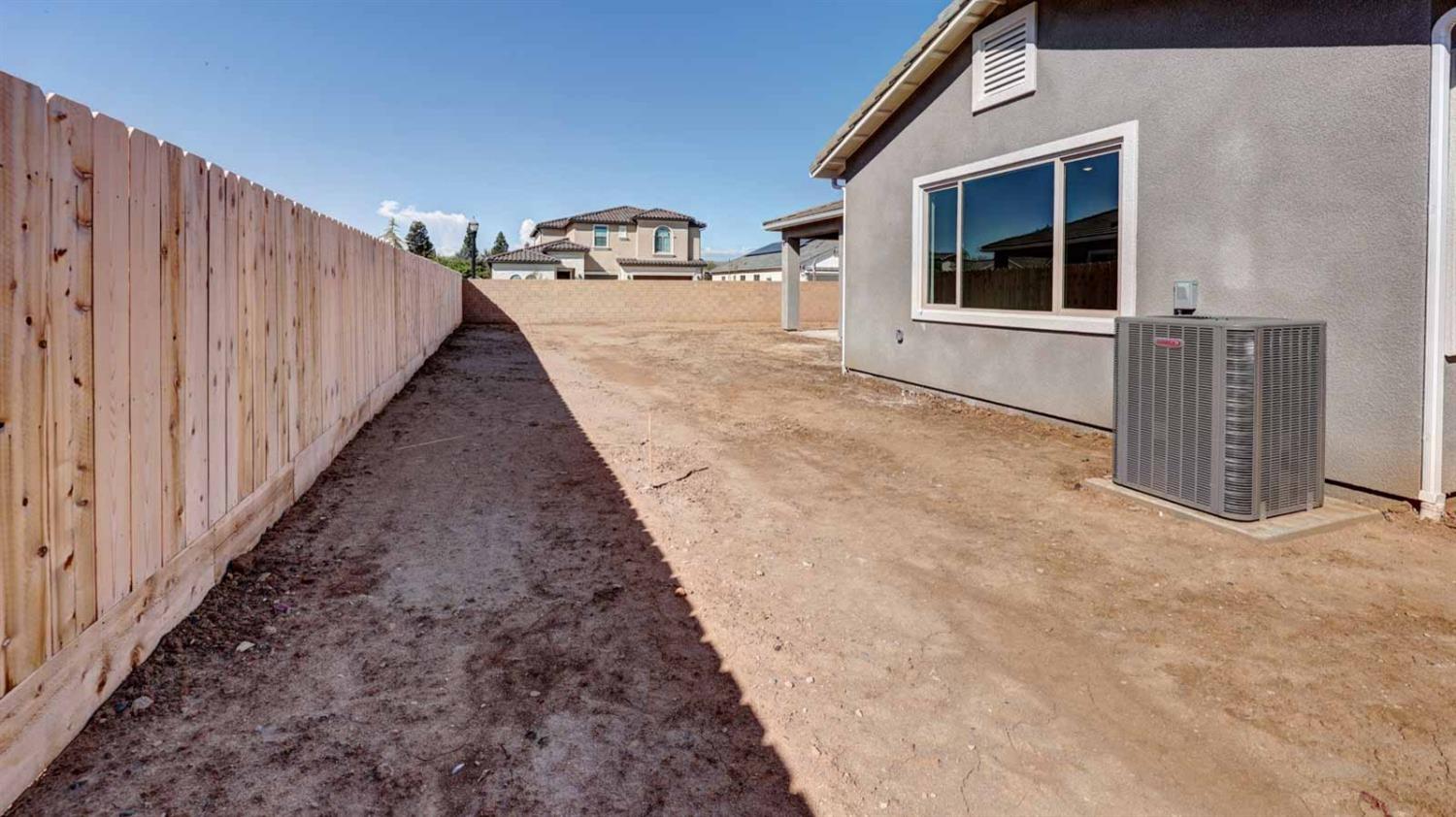 1742 North Applegate Avenue Clovis, CA 93619 - Photo 29 of 31 a view of a house with a backyard