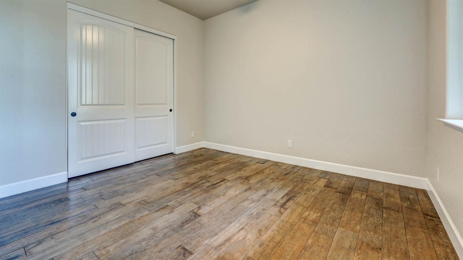 1742 North Applegate Avenue Clovis, CA 93619 - Photo 4 of 31 a view of empty room with wooden floor