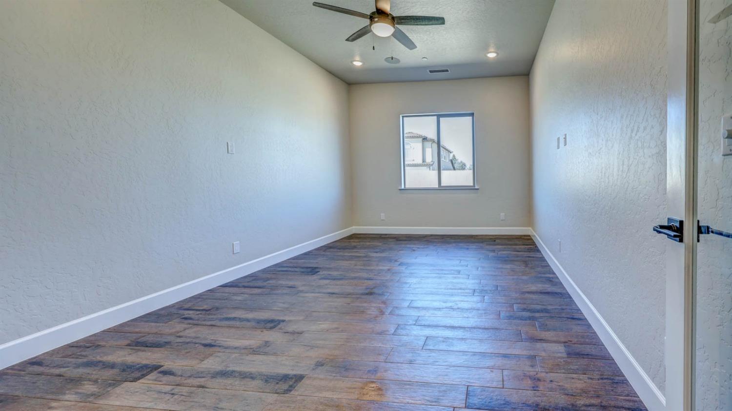 1742 North Applegate Avenue Clovis, CA 93619 - Photo 6 of 31 wooden floor in an empty room with a window