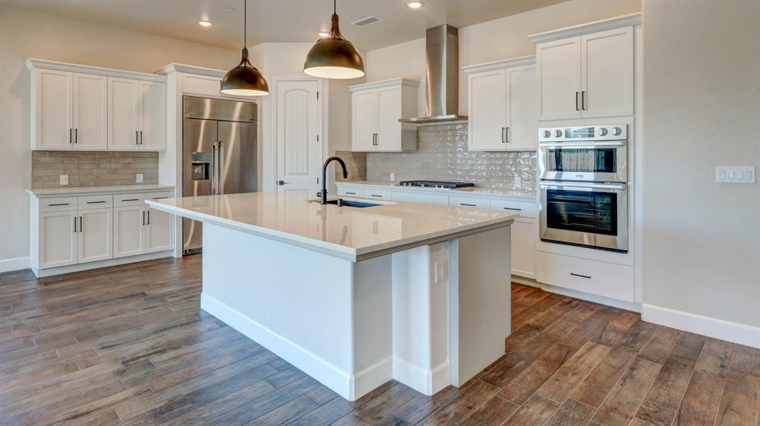 1742 North Applegate Avenue Clovis, CA 93619 - Photo 7 of 31 a kitchen with stainless steel appliances a sink and a stove top oven