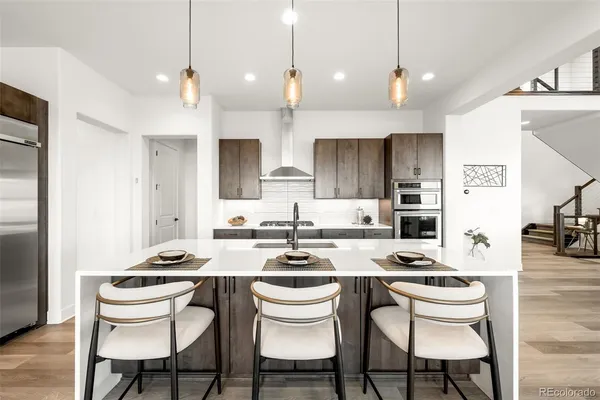 a kitchen with a dining table chairs and white cabinets