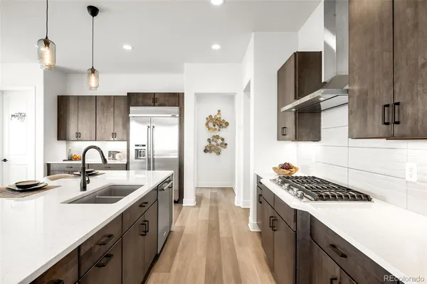 a kitchen with stainless steel appliances a sink stove and refrigerator