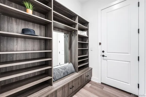 a view of walk in closet with clothes and shoes