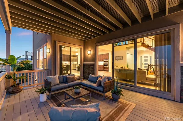 a living room with furniture a potted plant and a window