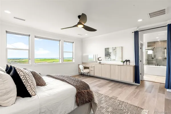 a bedroom with a large bed and a chandelier