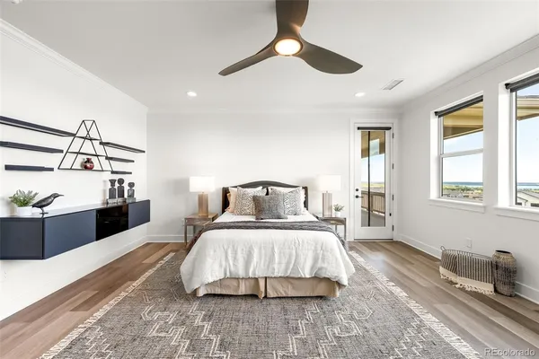 a large bedroom with a large bed and chandelier