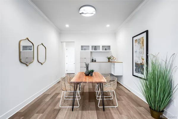 a dining room with furniture and a wooden floor