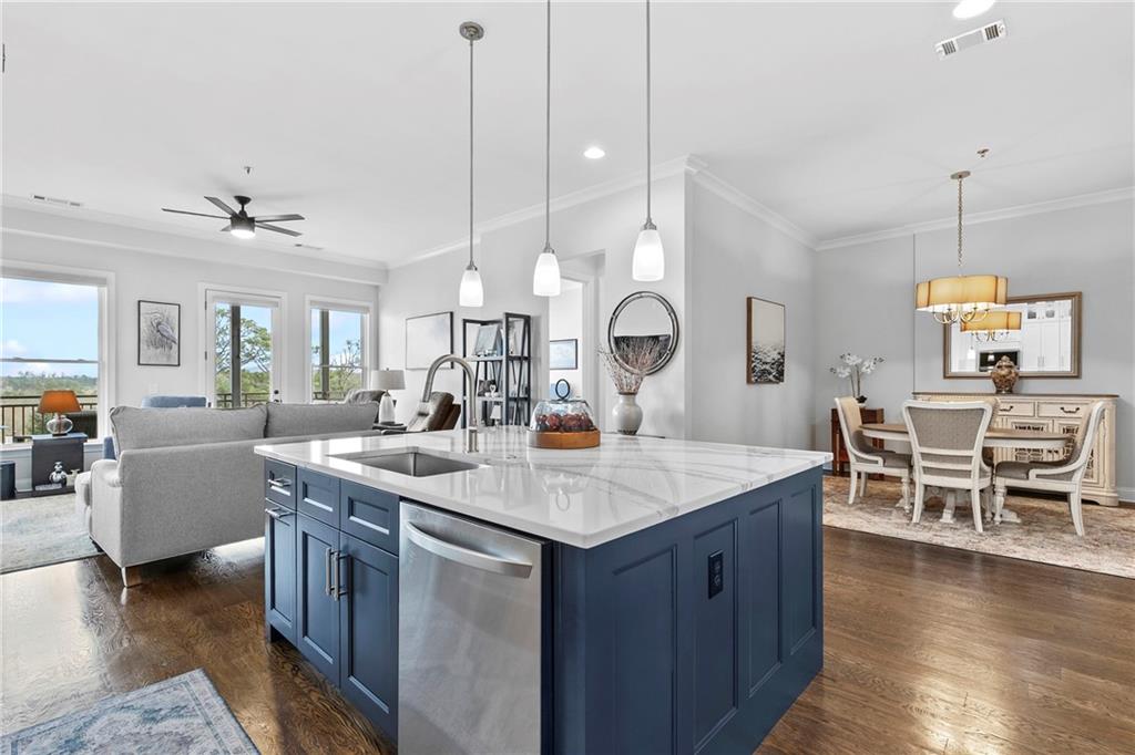 360 Chambers Street, Unit 309 Woodstock, GA 30188 - Photo 11 of 58 a room with stainless steel appliances kitchen island a table and chairs in it