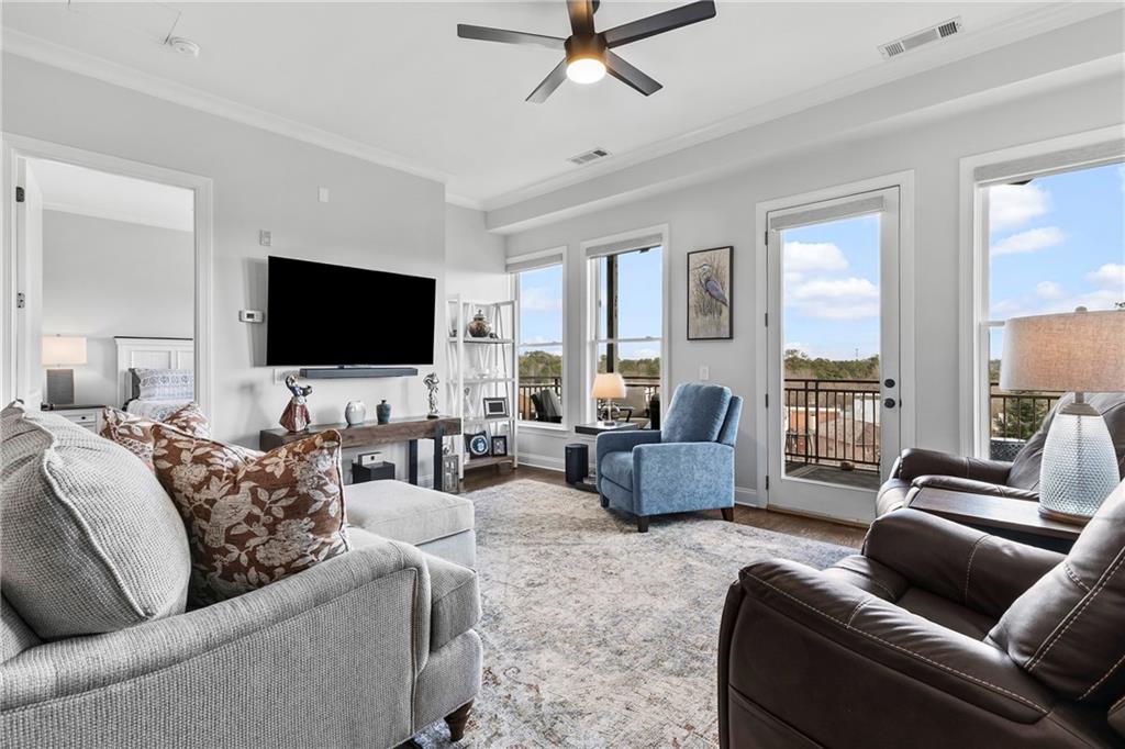 360 Chambers Street, Unit 309 Woodstock, GA 30188 - Photo 12 of 58 a living room with furniture and a flat screen tv