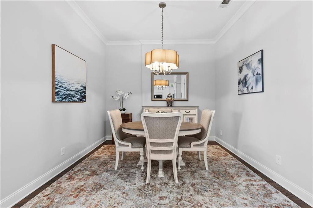 360 Chambers Street, Unit 309 Woodstock, GA 30188 - Photo 15 of 58 a dining room with furniture a rug and a window