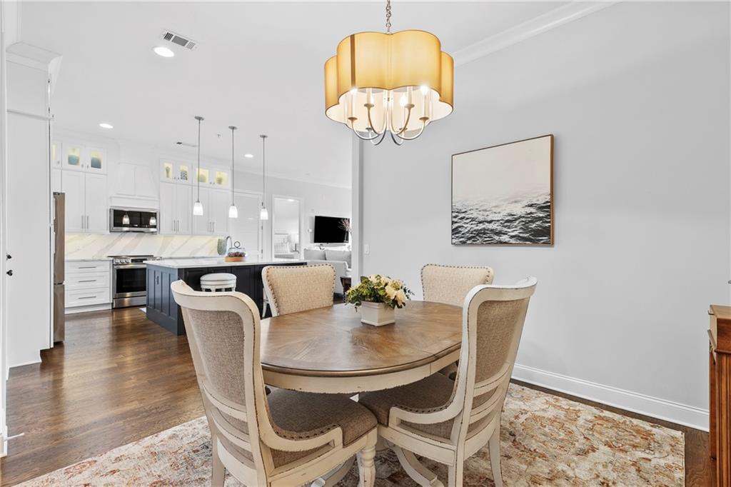 360 Chambers Street, Unit 309 Woodstock, GA 30188 - Photo 16 of 58 a dining room with furniture and a chandelier