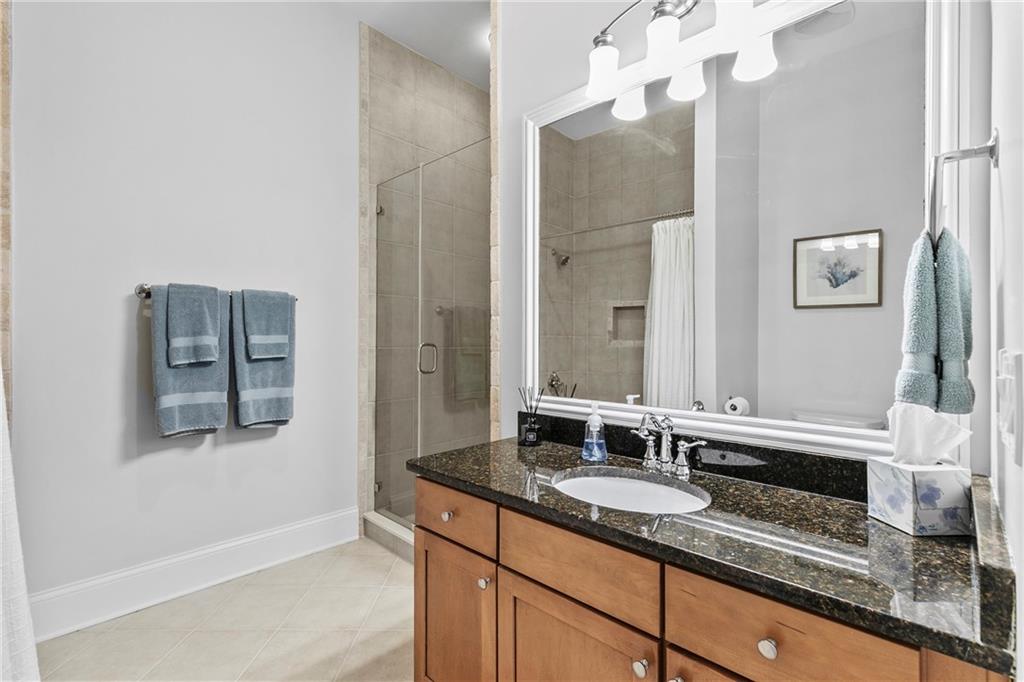 360 Chambers Street, Unit 309 Woodstock, GA 30188 - Photo 21 of 58 a bathroom with a sink and a mirror