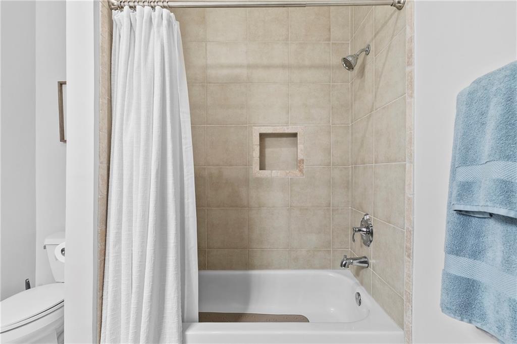 360 Chambers Street, Unit 309 Woodstock, GA 30188 - Photo 23 of 58 a bath tub sitting next to a white sink