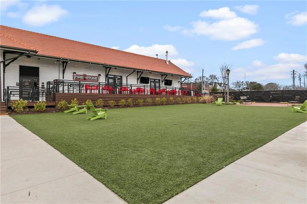 360 Chambers Street, Unit 309 Woodstock, GA 30188 - Photo 44 of 58 a front view of building with yard
