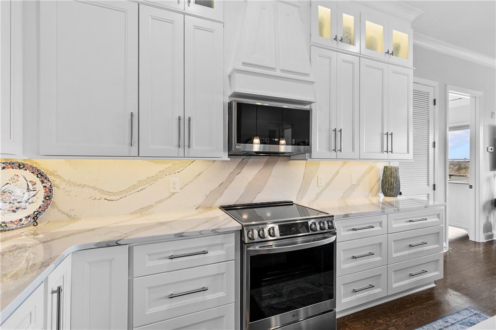 360 Chambers Street, Unit 309 Woodstock, GA 30188 - Photo 10 of 58 a kitchen with granite countertop white cabinets and stainless steel appliances