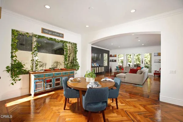 a view of a patio with table and chairs potted plants and large tree