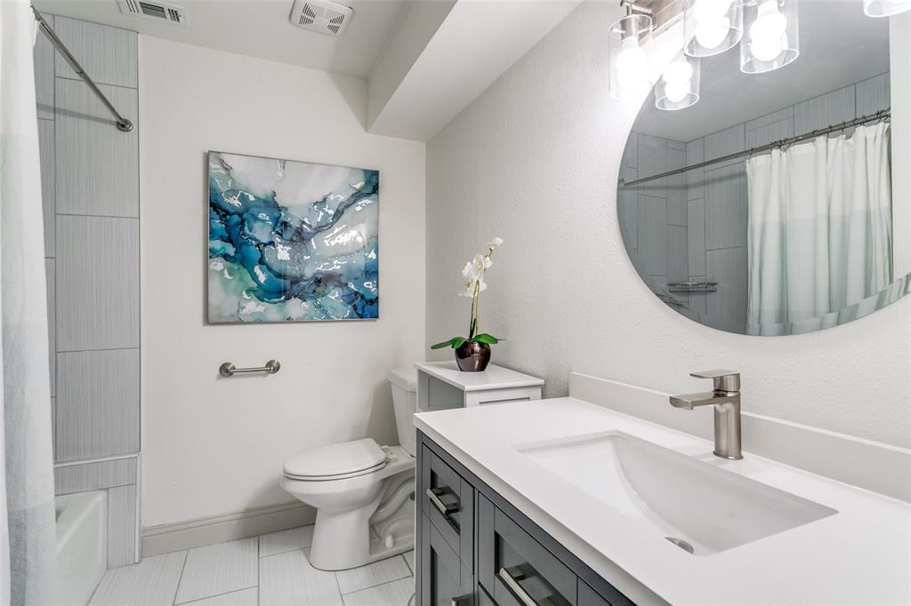 2922 Ridgewood Drive Grapevine, TX 76051 - Photo 20 of 25 a bathroom with a sink a toilet and a mirror