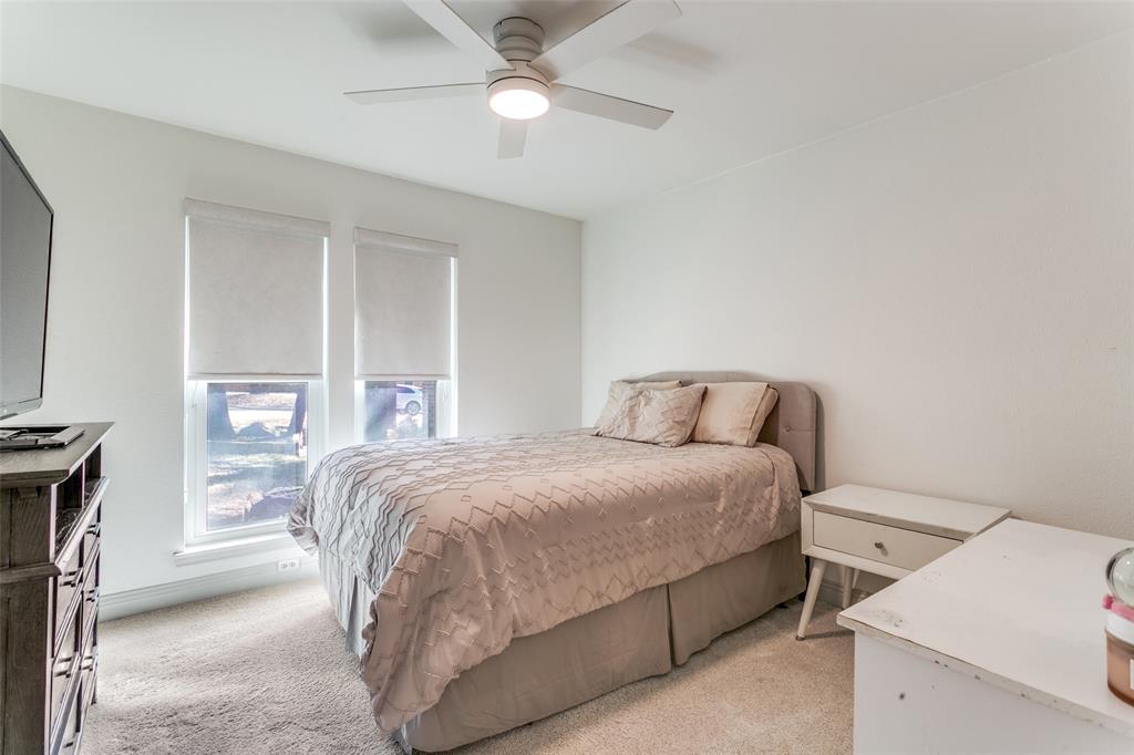 2922 Ridgewood Drive Grapevine, TX 76051 - Photo 21 of 25 a bedroom with a bed and a chandelier