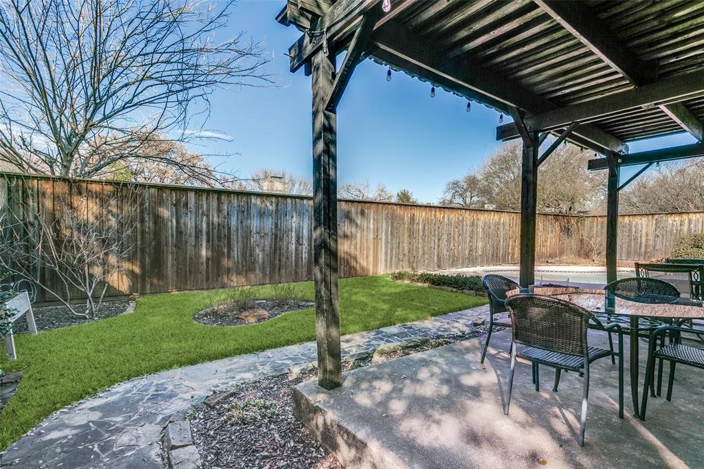 2922 Ridgewood Drive Grapevine, TX 76051 - Photo 22 of 25 a backyard of a house with a garden and outdoor seating